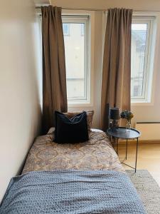 桑讷菲尤尔Moderne leilighet i sentrum av Sandefjord的一间卧室配有一张带枕头和桌子的床