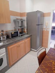 阿加迪尔أكادير حي السلام的厨房配有不锈钢冰箱和微波炉。