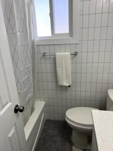 温尼伯Walking distance to St Boniface, easy parking的白色的浴室设有卫生间和窗户。