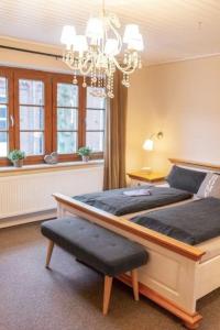 费马恩Kamin-Haus-Nr-3-mit-Sauna-in-Burg的一间卧室配有两张床和吊灯。