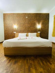 乌提Tulips Resorts - Elkhill的一间卧室设有一张大床,铺有木地板