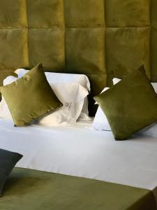 卡索里亚马萨尼尔洛豪华酒店的一张白色的床,上面有三个枕头