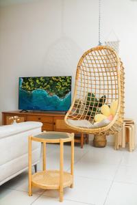 怡保The Horizon Ipoh By Iconique Espace的客厅配有藤椅和沙发