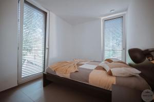 WakeUp Lux-City的一间卧室设有一张床和两个大窗户