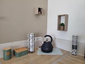阿维尼翁Maison au calme Avignon - Clim - Wi-Fi的茶壶坐在一个房间里的一个柜台上
