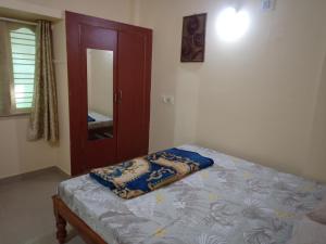 班加罗尔Bangalore homestay的一间卧室配有一张床、镜子和门