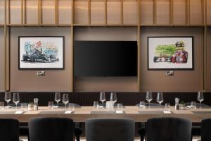 托斯特Hilton Garden Inn Silverstone的一间会议室,配有长桌子、椅子和投影屏幕