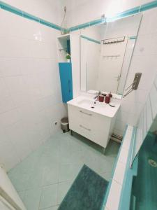 马里尼亚讷Appart 70m² plein sud的白色的浴室设有水槽和镜子