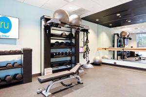 教堂山Tru By Hilton Chapel Hill的健身室,健身房设有长凳和举重器材