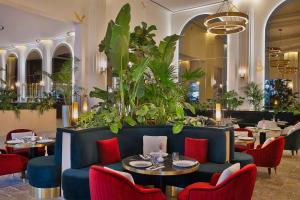 多哈Maysan Doha, LXR Hotels & Resorts的餐厅设有蓝色的沙发和桌椅