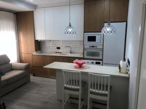 科尔多瓦ENMAYO 2021 - Dos alojamientos的厨房配有带2把椅子的厨房岛