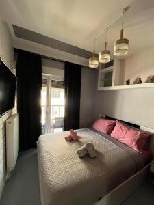 塞萨洛尼基VIP Apt. Pezodromos Kalamarias的一间卧室配有一张床,上面有两条毛巾