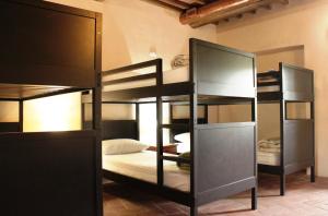 蒙特里久尼Ostello Contessa Ava dei Lambardi的一间房间,设有三张双层床