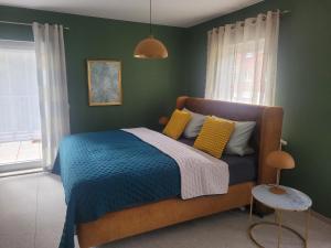 奥伯霍夫Pension & Ferienwohnung Oberhof 810 M的一间卧室配有一张带蓝色毯子和黄色枕头的床。