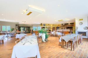 里帕尔贝拉Borgo San Pecoraio Resort的餐厅设有白色的桌椅和壁炉