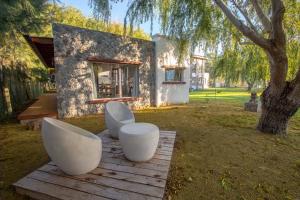 圣特雷西塔Mar & Campo的两把白色椅子和一棵树的房子