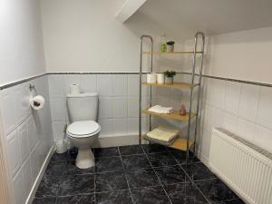 利物浦Great Apartman Liverpool的浴室设有卫生间和黑色瓷砖地板。