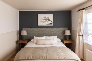 纳塔列斯港Bories - Boutique Guest House的一间卧室配有一张带2个床头柜的大床