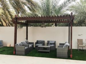 Bawsharفيلا مسقط - Muscat Villa的草坪上带长沙发和椅子的凉亭