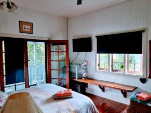 凯恩斯朱莉的民宿的一间卧室设有一张床和两个大窗户