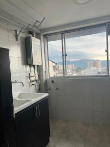 马尼萨莱斯LA CASA DEL CABLE -Atractivo Único Sector Cable 104-的一间带水槽和大窗户的浴室