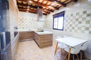 科尼尔-德拉弗龙特拉Vivienda Rural El Chirimbolo的厨房配有桌子、水槽和桌子