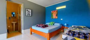 圣罗克Rancho Acácia São Roque的一间卧室设有一张床和蓝色的墙壁