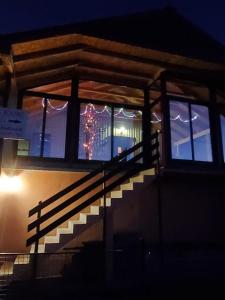 扎布利亚克Deluxe Studio & Rooms Zarubica的夜间窗户上带有圣诞装饰的楼梯