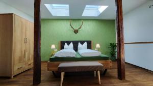 韦尼格罗德Traditions - Hotel "Zur Tanne"的一间卧室配有一张带绿色墙壁的床