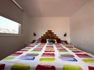 托雷维耶哈Chalet en La Mata a 50 metros de la playa的一间卧室配有一张大床和五颜六色的被子