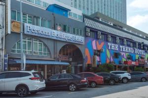 马六甲Persona Boutique Hotel的停在大楼前的一组汽车