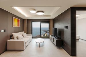 釜山NewCZ Osiria Residence的带沙发和电视的客厅