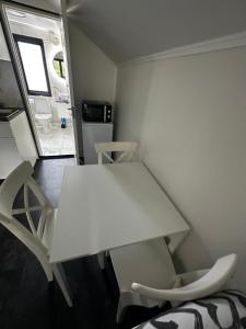布罗斯independent apartment near citycenter/lake的小房间配有白色的桌子和椅子