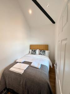 诺里奇75 Weavers Townhouse的卧室配有一张带白色墙壁的大床