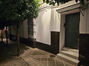 麦地那西多尼亚Apartamento Casa Pura的街道上设有门和楼梯的建筑