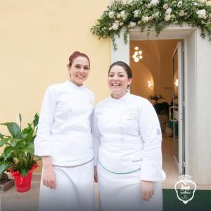 卡斯特罗齐耶罗Villa Euchelia的身穿白色制服的两名妇女彼此相邻
