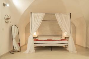 加利波利Romantic Suite的卧室配有带白色窗帘的天蓬床