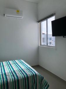 科韦尼亚斯Hermoso Apartamento en Caribe Campestre的白色的客房设有床和窗户。