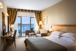 奥瑞比克阿米内斯格兰德阿祖尔酒店的酒店客房配有一张床,享有水景