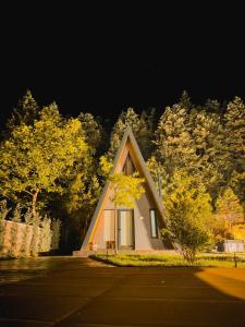 帕弗兰尼Pavliani4rest - Luxury Cabins的树前有三角形屋顶的小房子