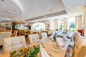 亚琛比斯玛克图姆酒店的一间带长桌和椅子的用餐室