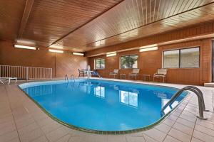 滑铁卢滑铁卢贝蒙特套房酒店的酒店客房的大型游泳池配有桌椅