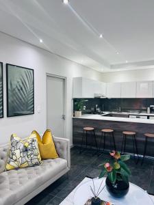 约翰内斯堡@ORRIE Apartments Infinite的带沙发的客厅和厨房
