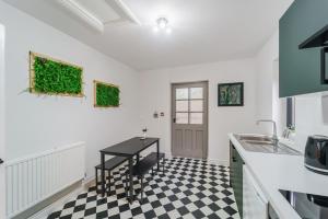德比Deluxe Studio Apartments的厨房铺有黑白的格子地板。