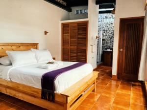 圣马科斯拉拉古纳El Dragon Hotel的一间卧室配有一张带木制床架的床