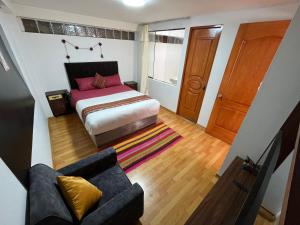 库斯科Cusco Rooms的一间带床和沙发的小卧室