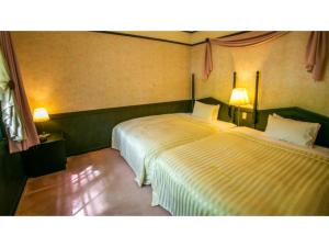 白马村Restaurant & Hotel Traumerei - Vacation STAY 47777v的配有两张床铺的房间,配有两盏灯