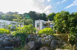 今归仁村Vacation Village Okinawa - Yambaru的前面有岩石花园的房子
