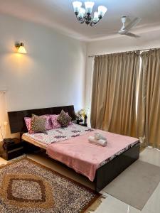 达波林Good Stay Premium Studio Apartment 206的一间卧室配有一张带粉色毯子的大床