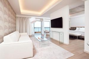 罗德镇地中海酒店的客厅配有白色沙发和电视